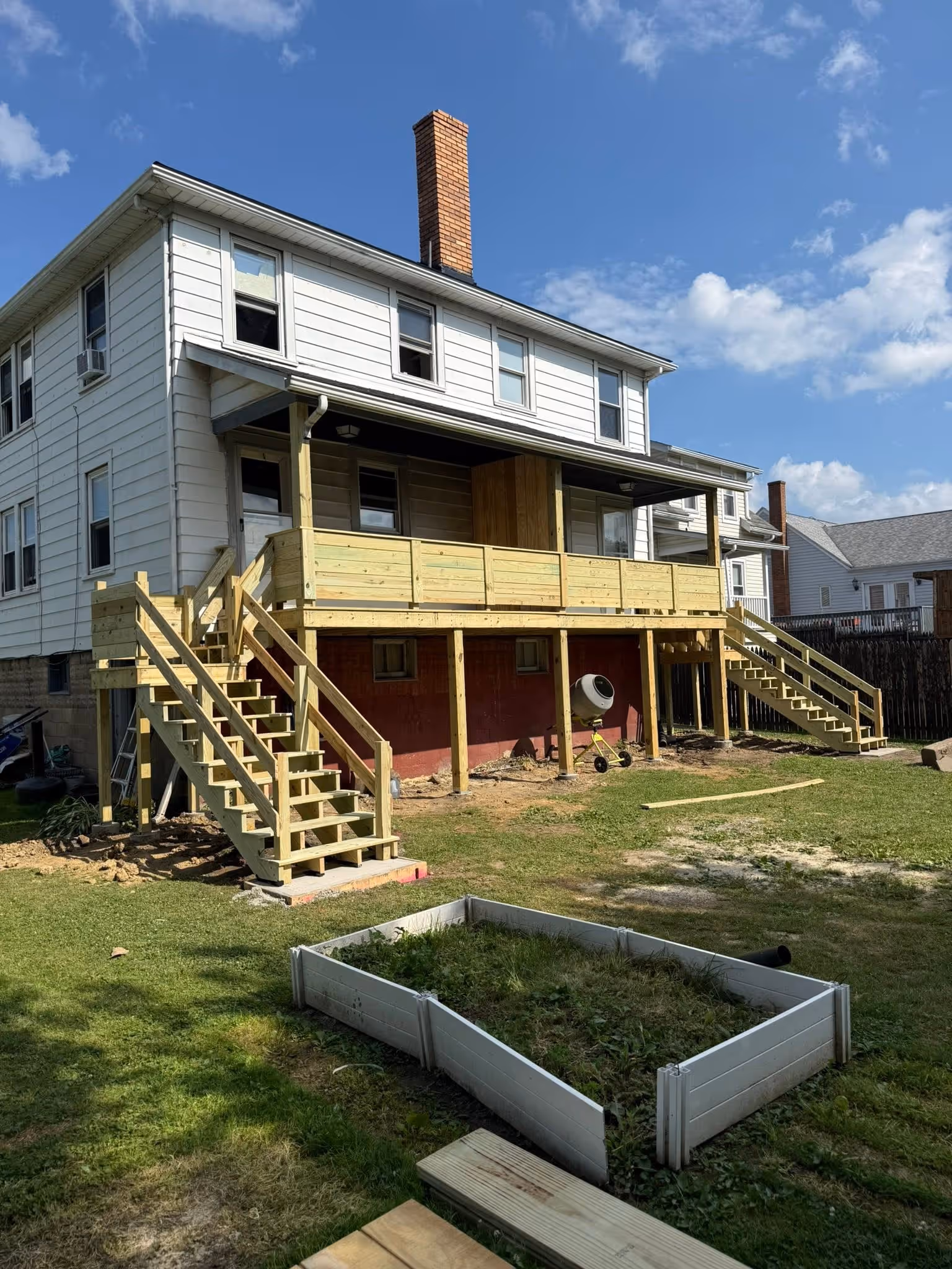 Rear exterior of a house during deck construction