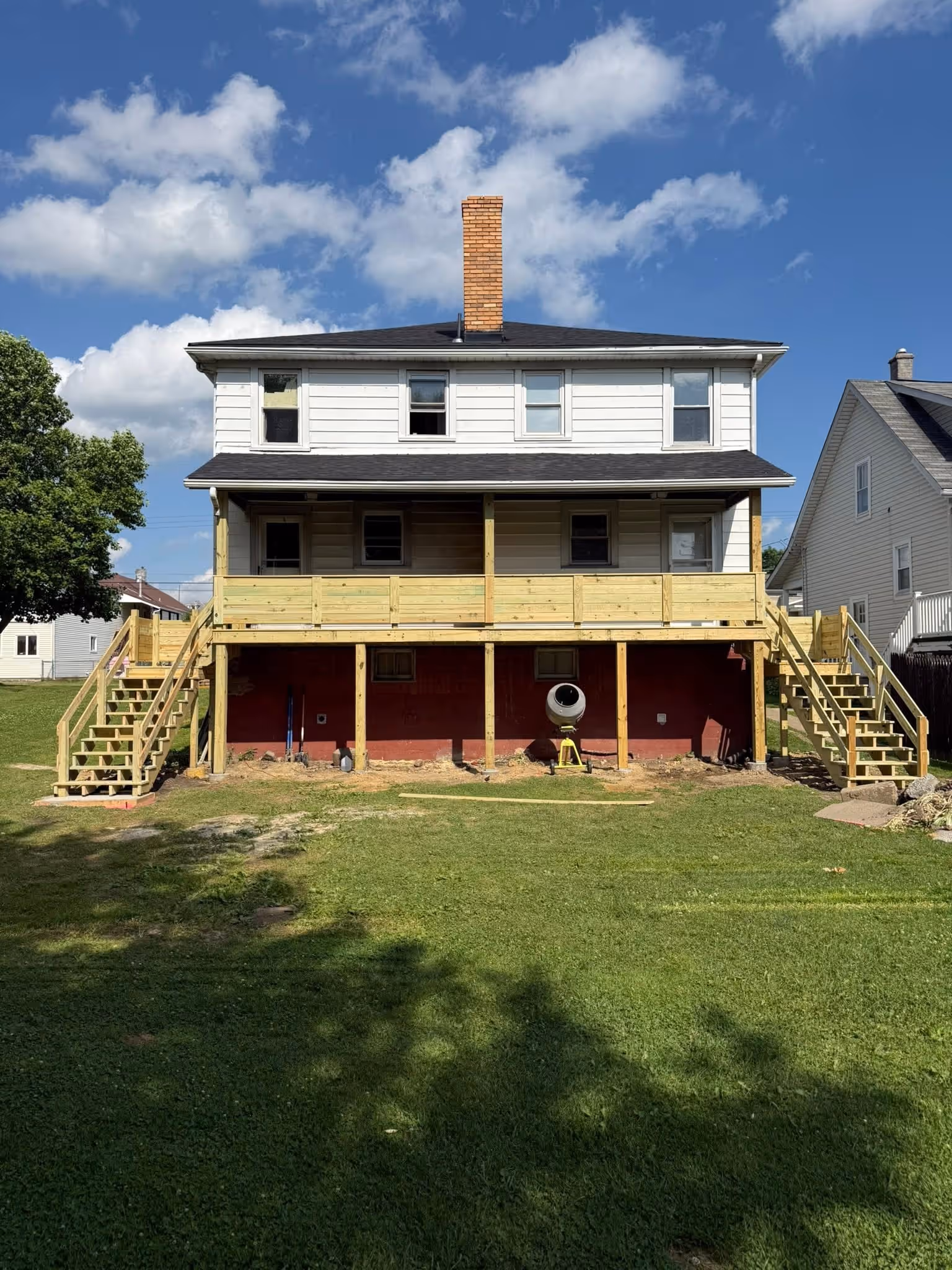 House exterior with a newly built raised deck
