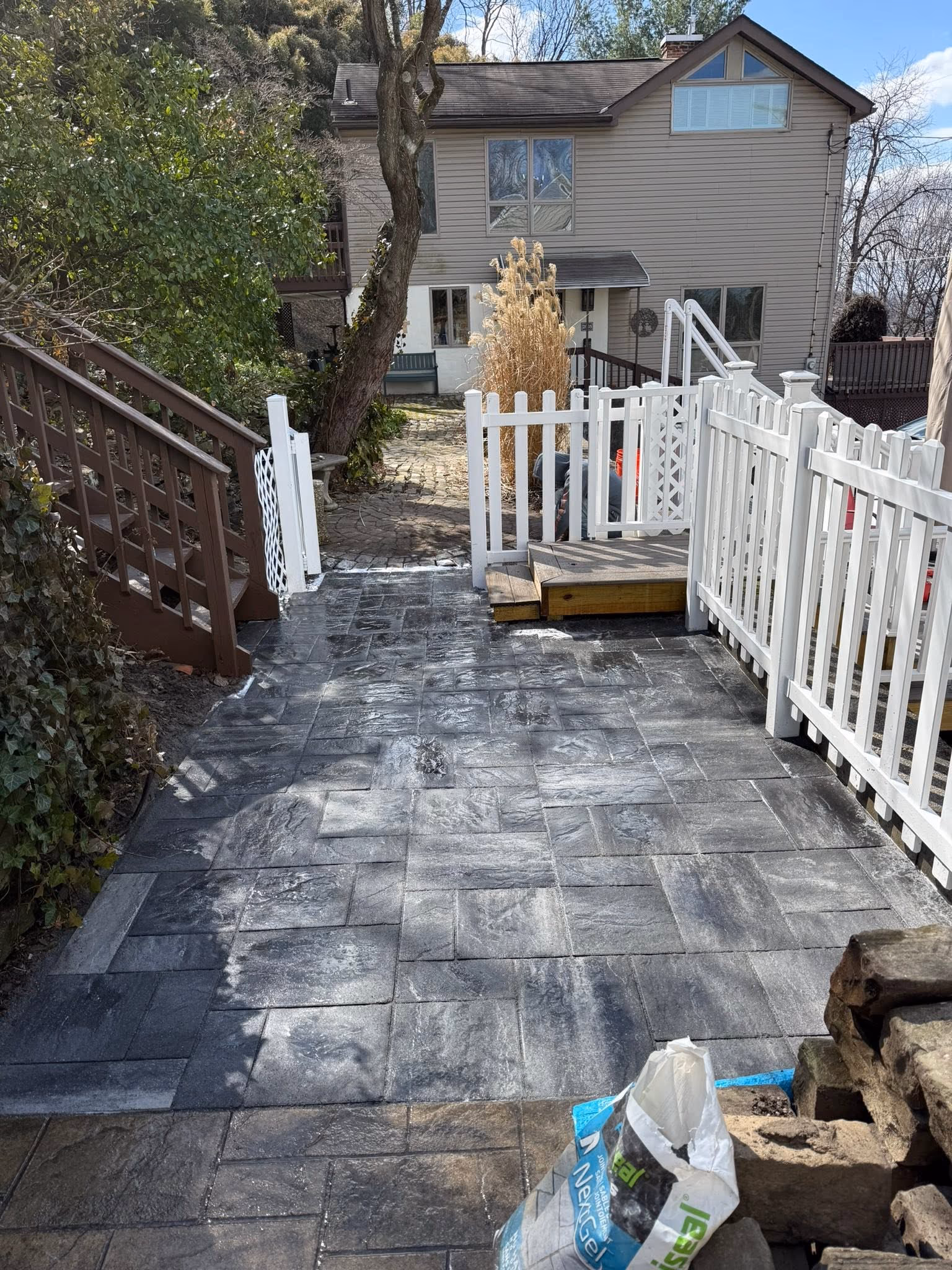 Gray paver walkway and landing viewed downhill