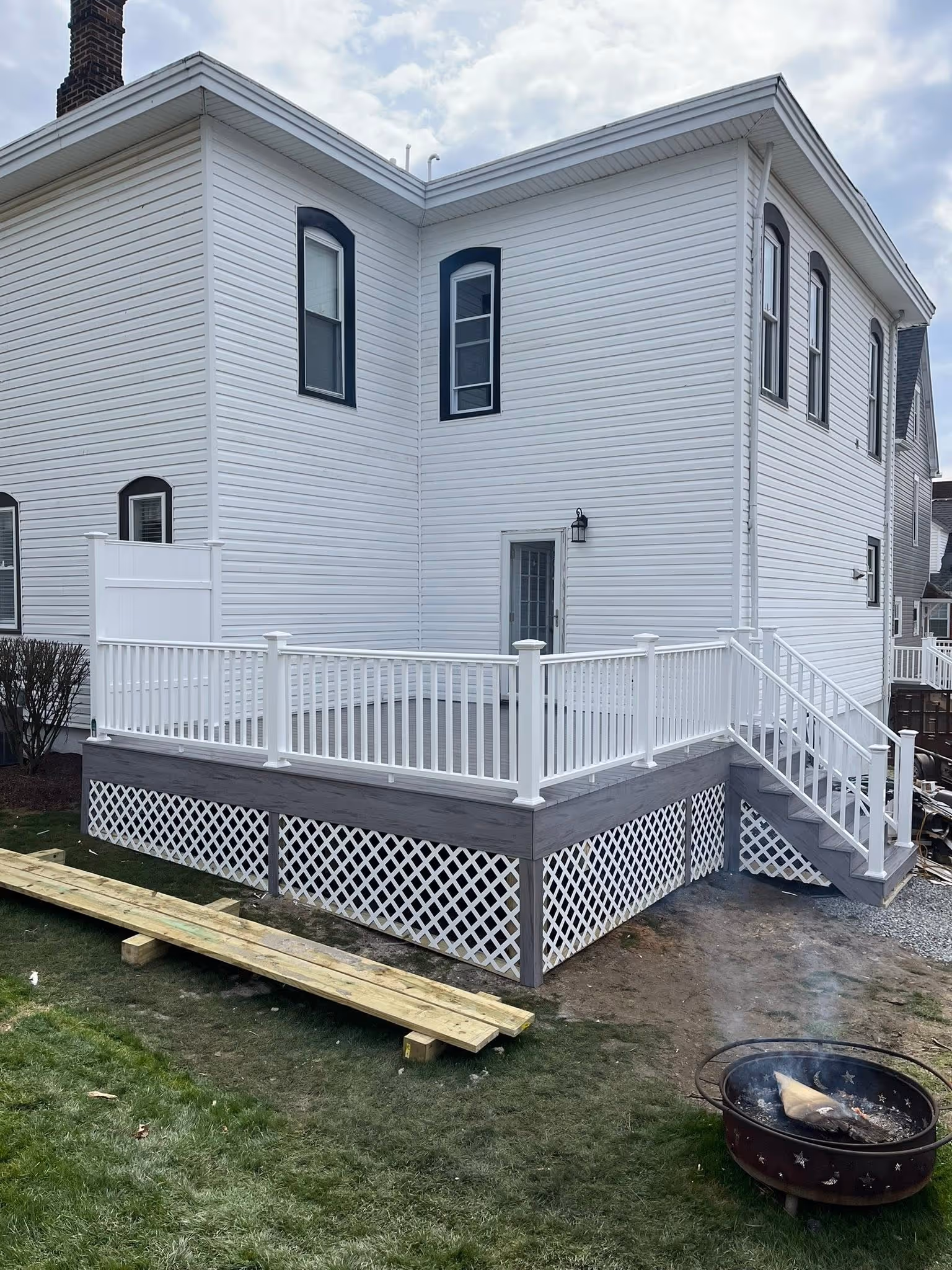 New exterior stairs, landing, and white railing